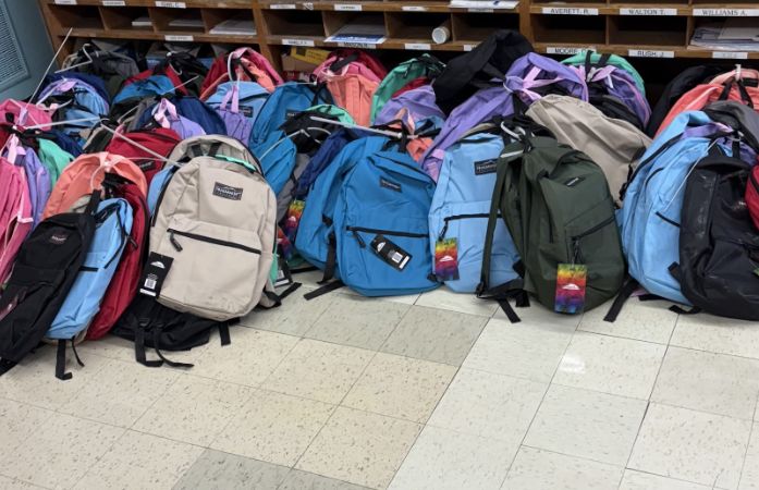  backpacks lined up on the floor